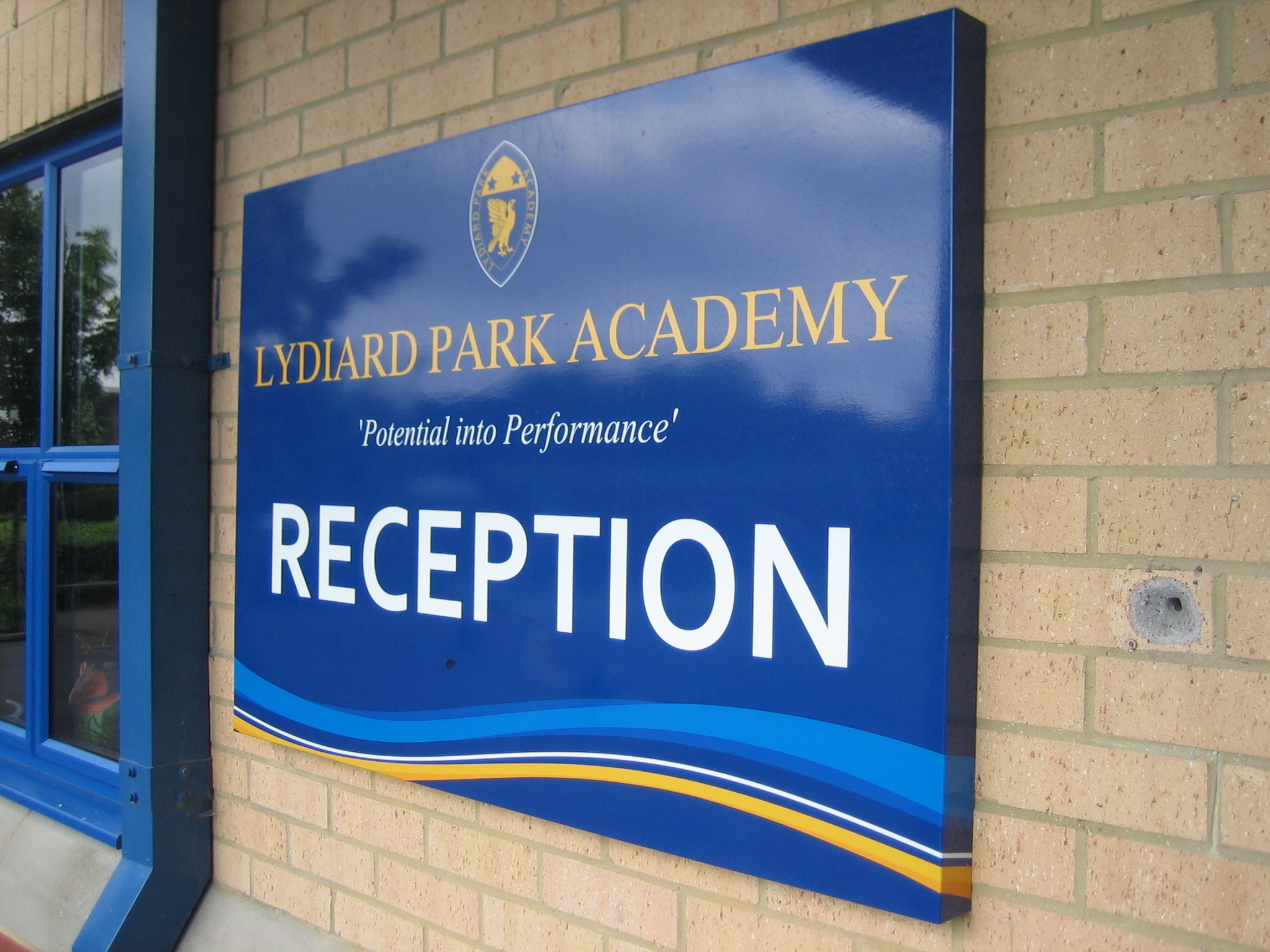 Box tray sign installed on a school building